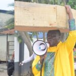 Nigerian Archbishop Protest Against President Buhari With Heavy Coffin On His Head [Photos] 3
