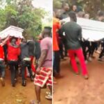 Drama As Corpse Carried By Over 20 Able-Bodied Men Refuses To Be Buried [Video]