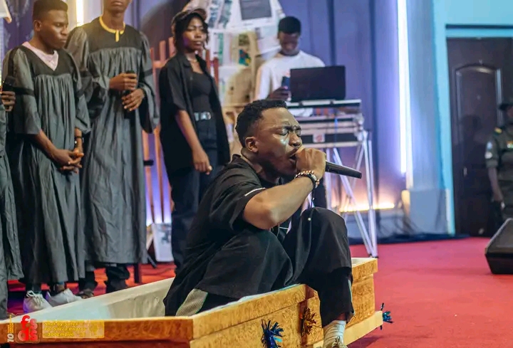 Outrage As Gospel Singer Onoja Arrives On Stage In Casket To Perform In Church [Photos]