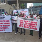 Nigerian Contractors Protest Unpaid Contracts, Block Finance Ministry Gate In Abuja [Video]