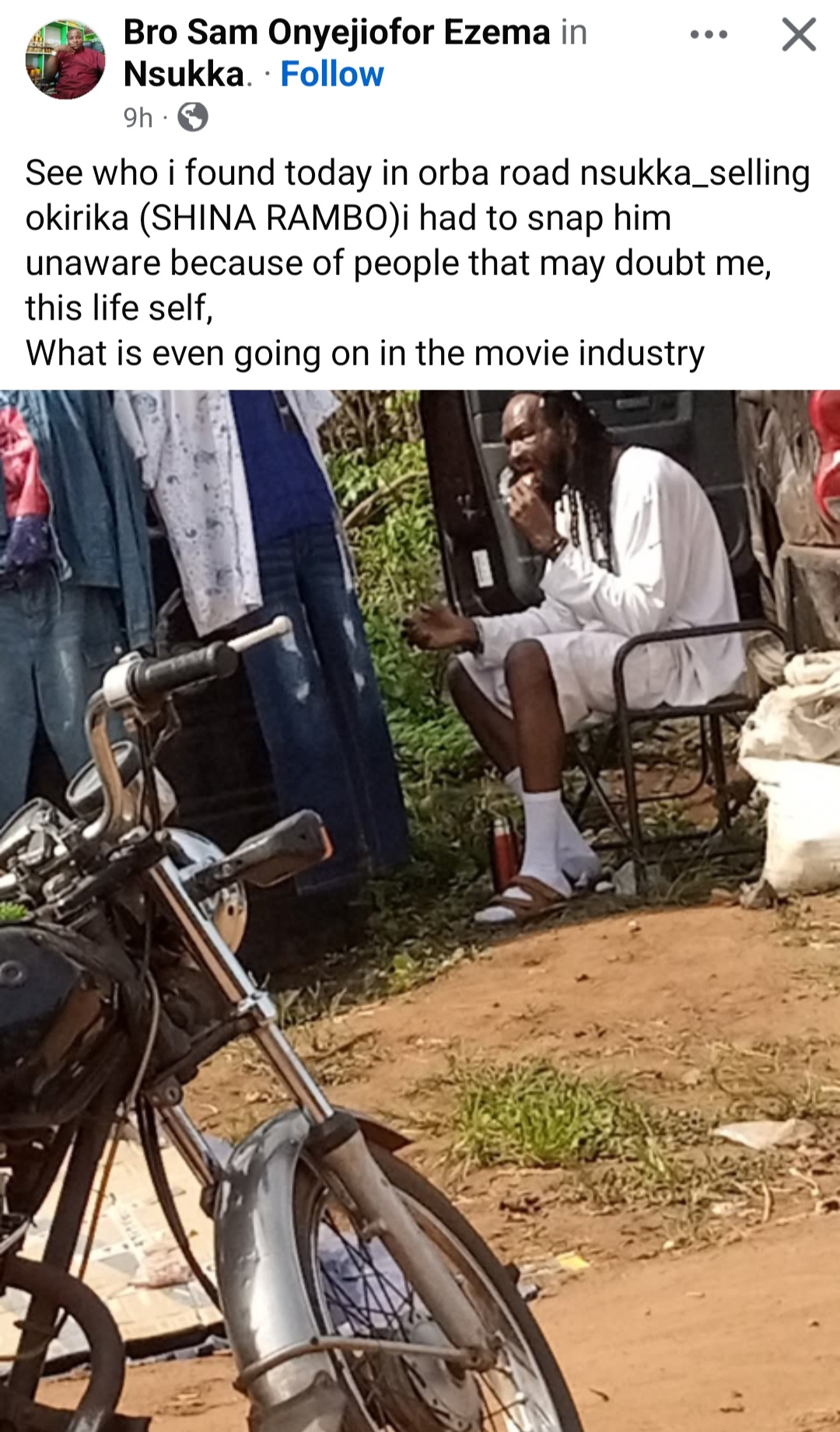 Outrage As Man Shares Photo Of Actor Sylvester Madu Selling Clothes And Eating On Bushy Road