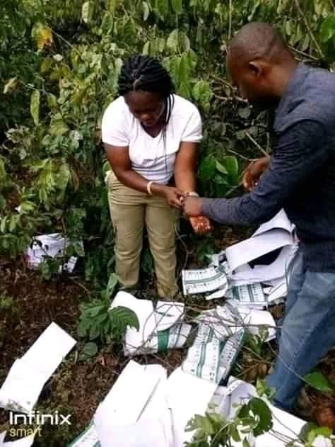 Youth Corper caught inside the bush thumb printing ballot papers for APC - PHOTOS 2